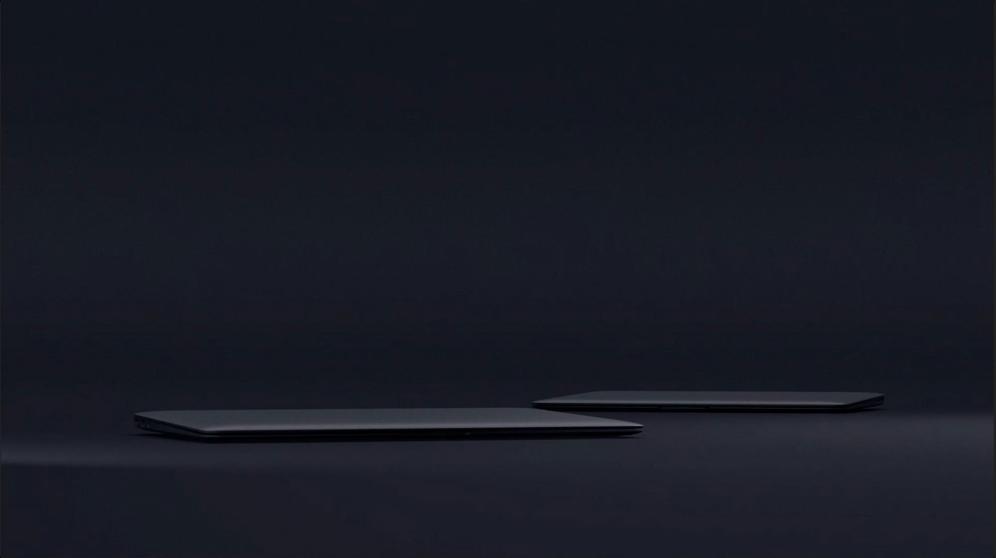 Two closed dark laptops on dark background. Illustration.